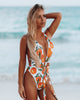 Wrap around swimsuit with vibrant print and a sexy open back for the beach